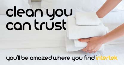 A person carrying a stack of white linen