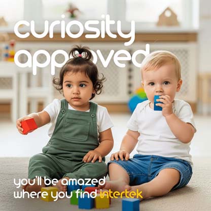 Two infants sitting on the floor with some toys